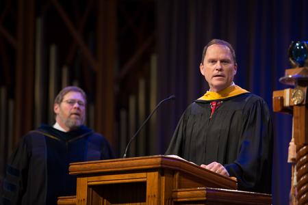 Gary Carter, senior vice president for business services, announces this year's Staff Member of the Year, Wendy Glass, during Awards Day chapel. - Photo by Kristi McMurry Woody