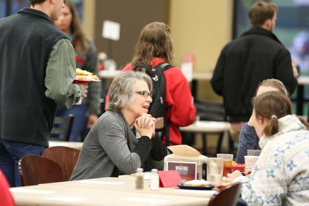 Dottie Myatt, professor of education, talks with students during a prayer breakfast held in conjunction with the National Day of Prayer.  - Photo by Kristi McMurry Woody