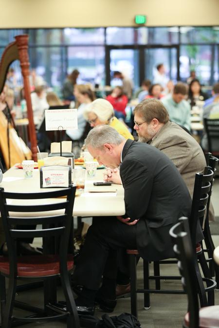 Dub Oliver, president of the university, joins colleagues and students in prayer during the prayer breakfast held in conjunction with the National Day of Prayer.  - Photo by Kristi McMurry Woody