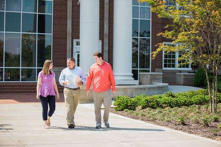 Jessica Vineyard, senior mathematics major, Chris Hail, professor of mathematics, and John Gollihugh, senior mathematics major, walk across campus near The Logos. - Photo by Kristi McMurry Woody