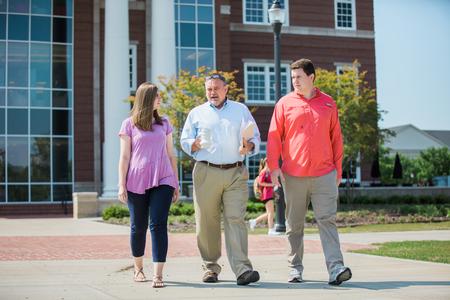 Jessica Vineyard, senior mathematics major, Chris Hail, professor of mathematics, and John Gollihugh, senior mathematics major, walk across campus near The Logos. - Photo by Kristi McMurry Woody