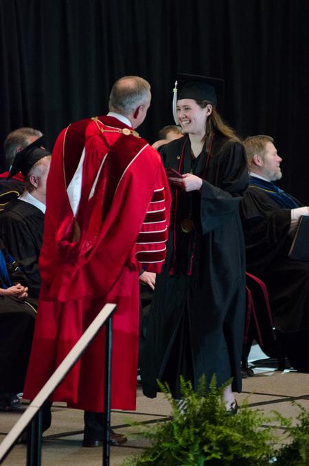 Audrey McKnight, senior communication arts major, receives her diploma at the spring 2017 graduation ceremony.  - Photo by Gretchen Foels