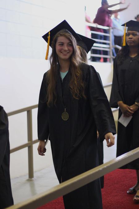 Marisa Infield, senior social work major, walks into the class of 2017 graduation ceremony.  - Photo by Riley Boggs