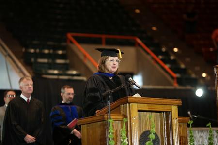 Carla Sanderson, provost of Chamberlain University, reads from Isaiah at the beginning of spring commencement.  - Photo by Kristi McMurry Woody