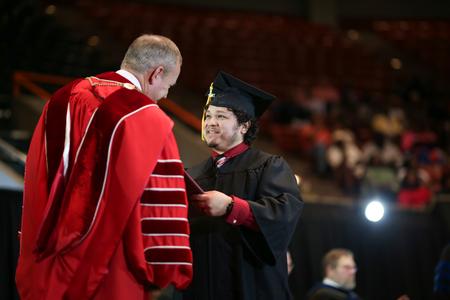Michael Aldana, BSOL graduate, receives his diploma during spring commencement.  - Photo by Kristi McMurry Woody