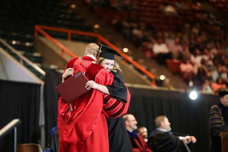 Senior class president and accounting graduate Hannah Willis, hugs Dub Oliver, president of the university, after receiving her diploma. - Photo by Kristi McMurry Woody