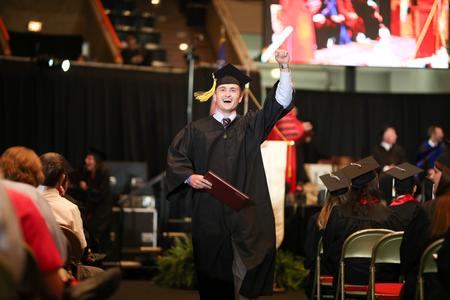 Caleb Scarbrough, teaching and learning and interdisciplinary studies graduate, celebrates after receiving his diploma. - Photo by Kristi McMurry Woody