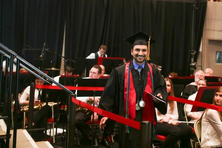 Joey Bakeer, cell and molecular biology graduate, smiles as he leaves the stage after receiving the Tigrett Medal.  - Photo by Kristi McMurry Woody