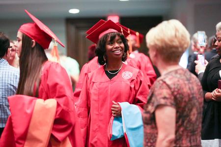 Countance Anderson, doctor of education graduate, looks around for her family and friends as she processes with fellow graduates into summer commencement.  - Photo by Kristi McMurry Woody