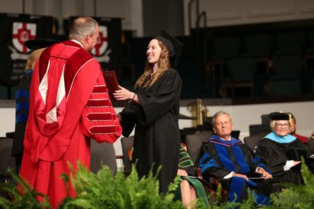 Elizabeth Atkins, organizational leadership graduate, receives her diploma during summer commencement.  - Photo by Kristi McMurry Woody