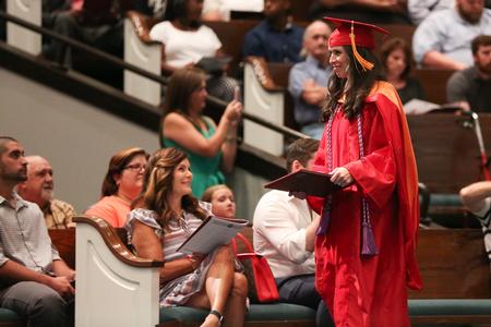 Christian Coleman Haynes, doctor of nursing practice graduate, walks back to her seat after receiving her diploma at summer commencement.  - Photo by Kristi McMurry Woody