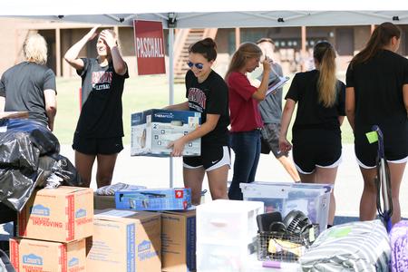 Members of the lady bulldog volleyball team help new students move in. - Photo by Kristi McMurry Woody