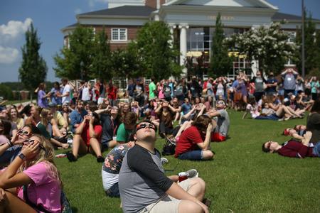 The Union family gathers together on the Great Lawn to view the solar eclipse.  - Photo by Kristi McMurry Woody