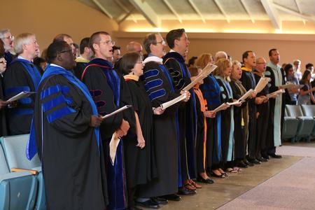 Faculty members join the congregation in singing during Convocation. - Photo by Kristi McMurry Woody