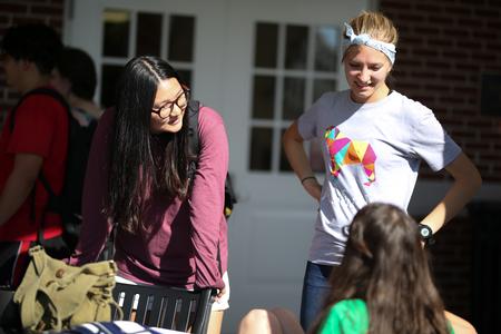 Song Kim, senior art studio major, and Janey Berends, senior Spanish major, chat with friends during MOSAIC's Cookout Connect. - Photo by Kristi McMurry Woody