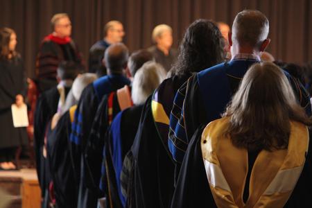 Faculty members stand during the processional during Convocation chapel. - Photo by Riley Boggs