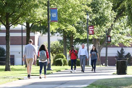 Dub Oliver, president of the university, walks to The Logos with some students.  - Photo by Kristi McMurry Woody