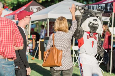 Buster the Bulldog high-fives a student's mother during Union Night on the Great Lawn. - Photo by Kristi McMurry Woody