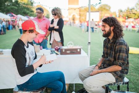 Ruth Duncan, art major, draws a portrait during Union Night on the Great Lawn. - Photo by Kristi McMurry Woody