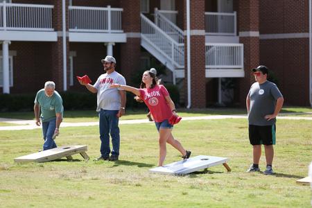 Family members of Union students enjoy a nice afternoon during the Family Weekend corn hole tournament.  - Photo by Kristi McMurry Woody