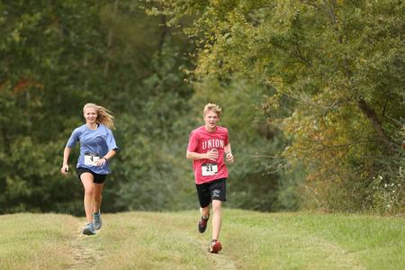 William Martin and his sister race to the finish line of the 5K on the Union Trails during Family Weekend. - Photo by Kristi McMurry Woody