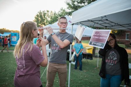 Students in the music department give lessons at their booth during Family Weekend Union Night.  - Photo by Kristi McMurry Woody