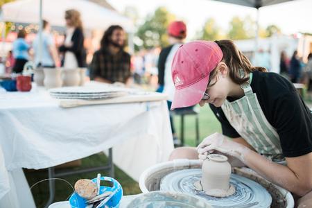 Aubrey Kurt, pre-professional art therapy major, throws some pottery at the Union Night art booth during Family Weekend. - Photo by Kristi McMurry Woody