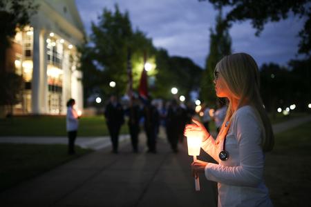 Social work students line the sidewalk by the Great Lawn during the Remember Me Commemorative Walk for Homicide-Loss Survivors. - Photo by Kristi McMurry Woody