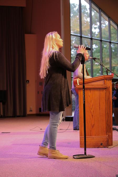 Sophomore Lydia Shoemaker leads chapel worship. - Photo by Hannah Heckart