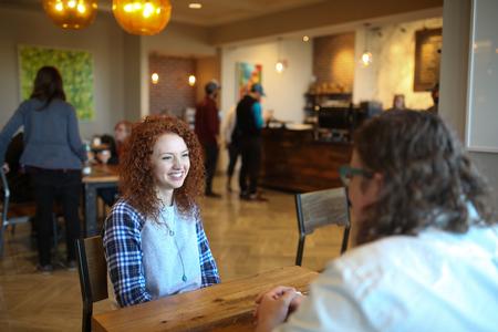 Mattanah DeWitt, journalism major, meets with Ted Kluck, assistant professor of communications, in Modero. - Photo by Kristi McMurry Woody