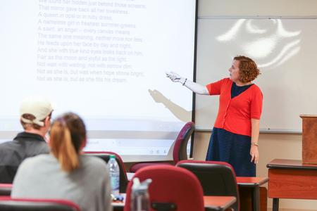 Janna Chance, associate professor of English, reads a poem in her class. - Photo by Kristi McMurry Woody