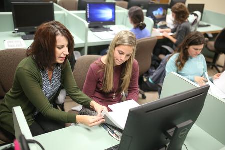 Chris Bailey, associate professor English and director of composition support, works with students in class on editing and publishing. - Photo by Kristi McMurry Woody