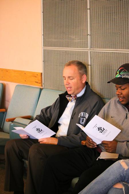Dub Oliver, president of the university, sings with students during chapel. - Photo by Hannah Heckart