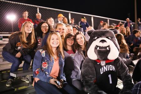 Students pose with Buster during a bulldog soccer game. - Photo by Kristi McMurry Woody