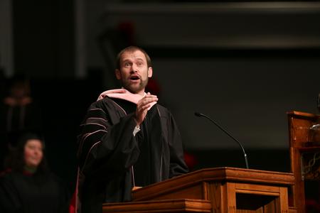 Dan Musselman, associate professor of music and acting chair, leads music during fall graduation. - Photo by Kristi McMurry Woody