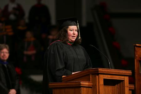 Rebekah McFarland, head athletic trainer, reads from Matthew 16 during fall graduation. - Photo by Kristi McMurry Woody