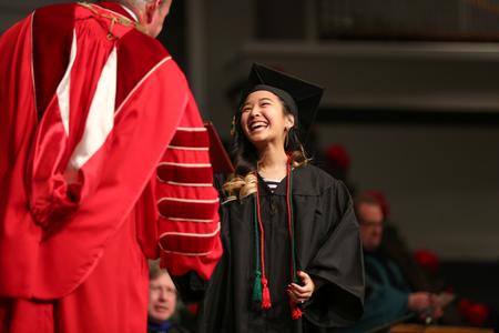 Jennifer Vo, biology graduate, receives her diploma during fall graduation. - Photo by Kristi McMurry Woody