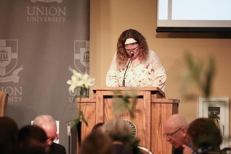Katie Moore, Union EDGE student, prays at the beginning of the EDGE fundraising event featuring HK Derryberry. - Photo by Kristi McMurry Woody