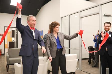 Dub Oliver, president of the university, and Lisa Rogers, chair of the board of trustees, cut the ribbon for the new writing center.  - Photo by Kristi McMurry Woody