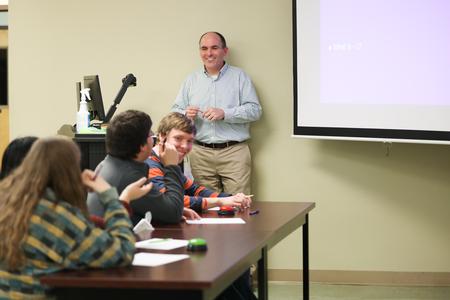 George Moss, associate professor of mathematics and department chair, hosts a game of math Jeopardy in the PAC. - Photo by Kristi McMurry Woody