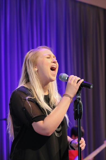 Lydia Shoemaker, music major, leads students in worship during chapel. - Photo by Hannah Heckart