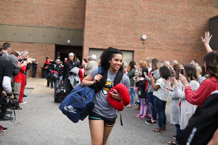Sara Lytle walks through a group of faculty, staff and students who are cheering for the Lady Bulldogs as they head off to play in the NCAA DII tournament.  - Photo by Kristi McMurry Woody