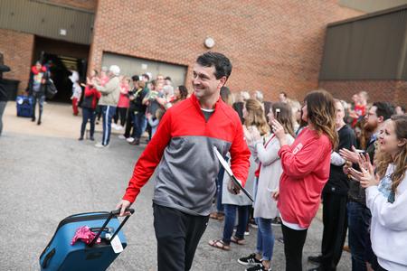 Mark Campbell, head women's basketball coach, walks through a group of faculty, staff and students who are cheering for the Lady Bulldogs as they head off to play in the NCAA DII tournament.  - Photo by Kristi McMurry Woody