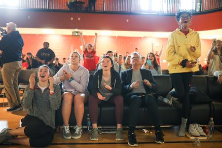 Paul Jackson (seated), professor of Biblical studies, and several students react to a good play by the Lady Bulldogs during the simulcast of the Elite Eight game in the NCAA DII tournament. - Photo by Kristi McMurry Woody