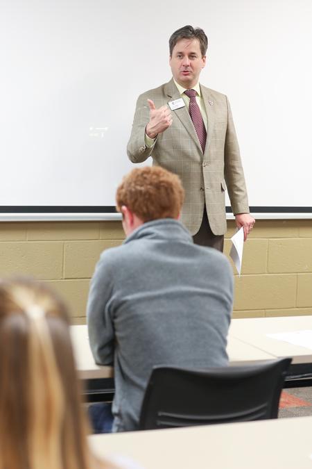 Jason Garrett, dean of the McAfee School of Business, explains the Case Competition sponsored by JEA and The Co during Business Week.  - Photo by Kristi McMurry Woody