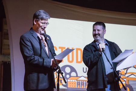 Chris Blair, professor of communication arts, and Cam Tracy, web development agent, present awards to student filmmakers at the annual Student Film Festival. - Photo by Janelle Vest