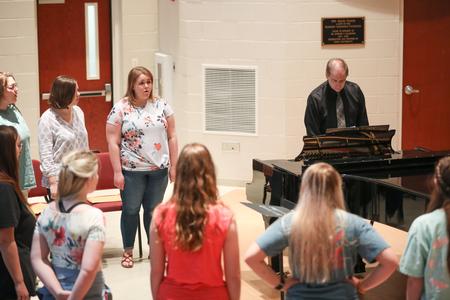 Cantilena, a women's choir at Union University, warms up with David Dennis, professor of music.  - Photo by Kristi McMurry Woody
