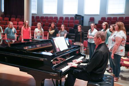 David Dennis, professor of music, leads Cantilena in warm-ups. - Photo by Kristi McMurry Woody
