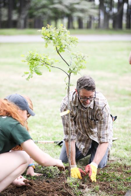 Michael Schiebout, associate professor of biology, helps plant trees during a biology class outing before Arbor Day. - Photo by Kristi McMurry Woody