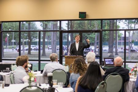 Chris Blair, professor of communication arts, speaks about the history of Walt Disney at the annual Phi Alpha Theta Banquet.  - Photo by Janelle Vest
